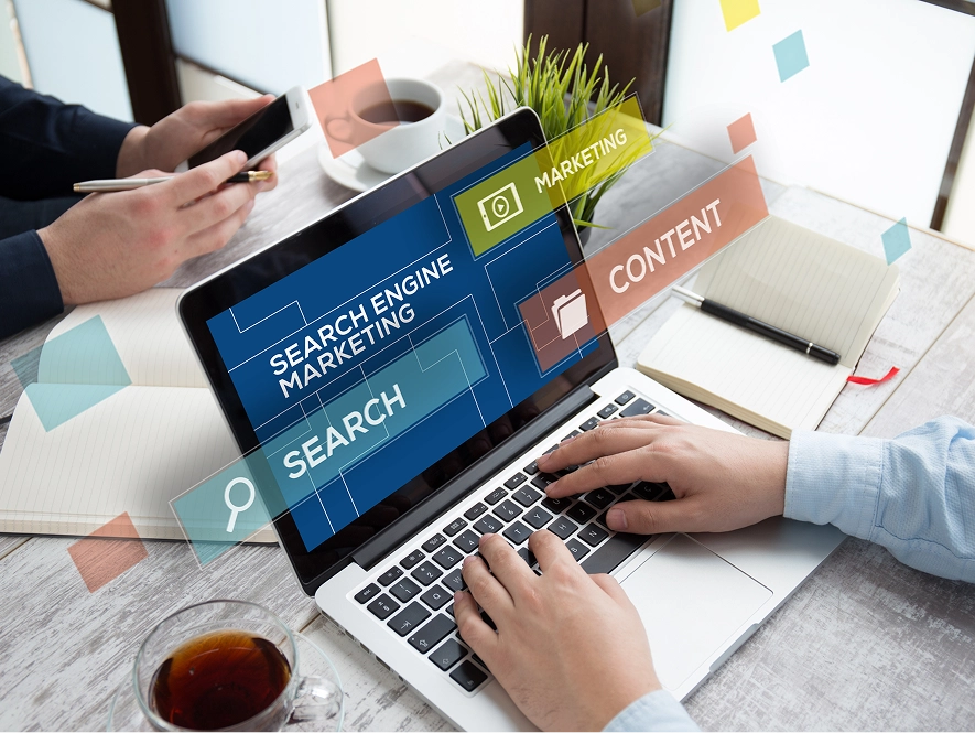 White label blog writing services — person working on laptop with SEO, marketing, search and content topics visible