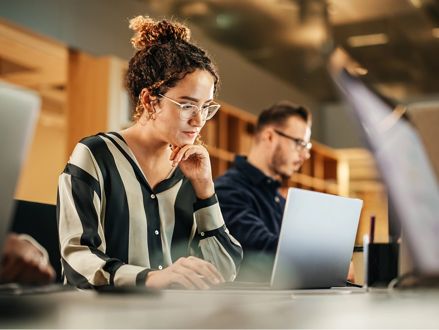 White label content turnaround times — professional focusing on laptop managing content delivery timelines and production workflow