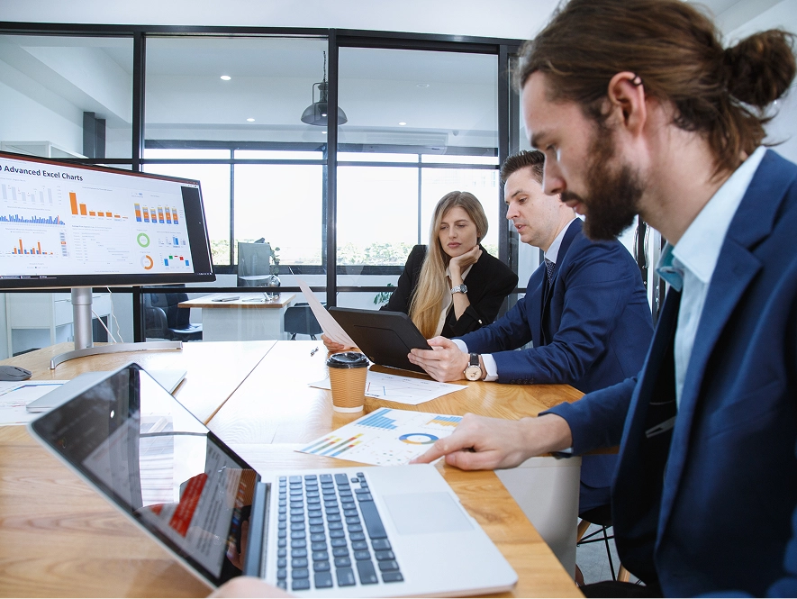 White label dental technical SEO and on-page excellence — team working on laptops and desktops with analytics graphs on screen