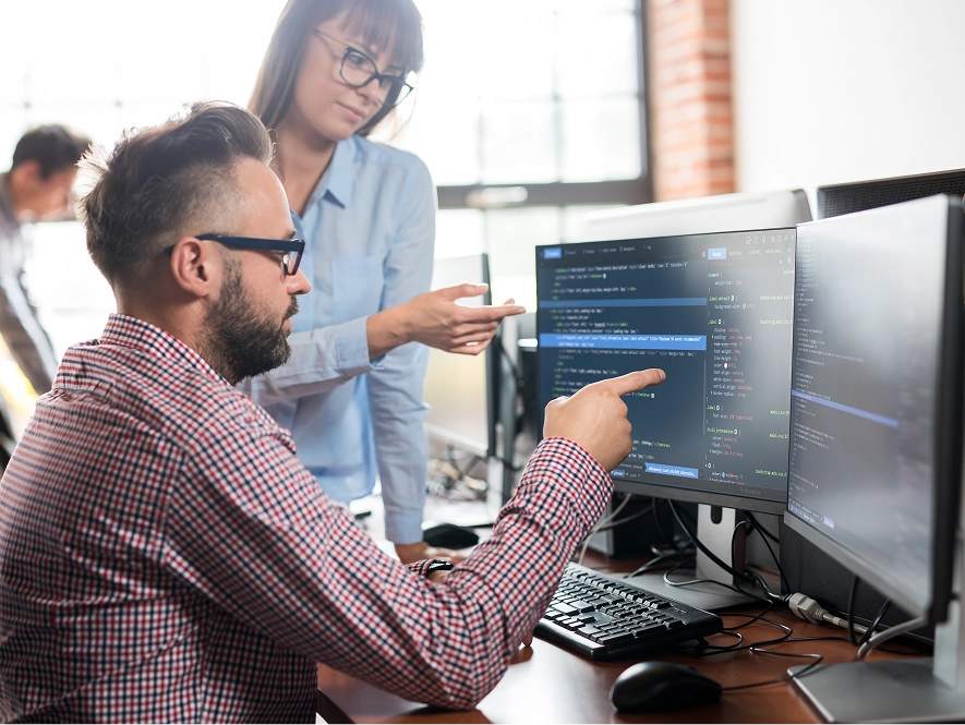 White label Framer site care and maintenance — team discussing and interacting with desktop screen for ongoing support