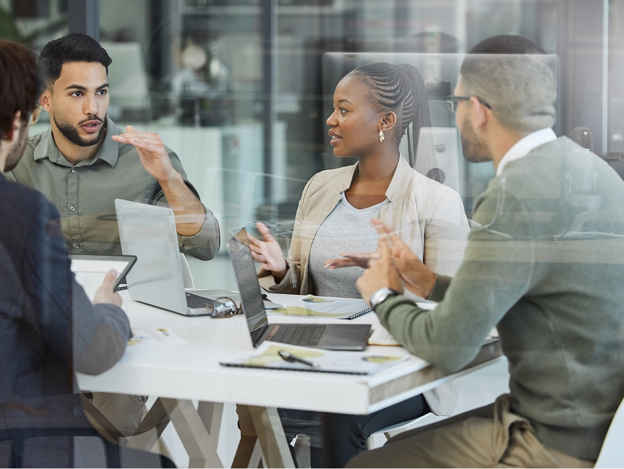 White label high-volume content production — team collaborating with laptops to manage multiple content projects and scalable delivery