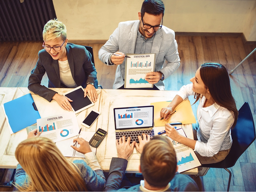 White label law firm technical SEO and on-page excellence — team collaborating with laptops, iPads, and graph papers for optimization planning