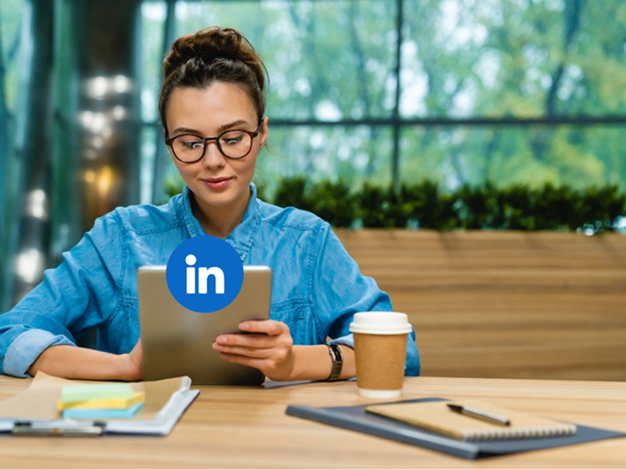 White label LinkedIn Ads strategy, funnel mapping and account setup — professional using iPad on table with LinkedIn interface