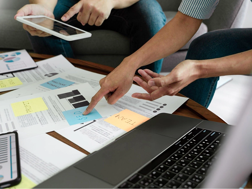 White label local SEO audit and strategy roadmap — team reviewing notes and documents on table to plan structured local SEO strategy