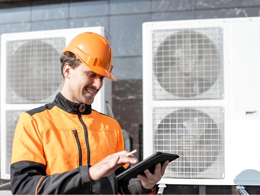 White label local SEO for HVAC companies — technician reviewing system data on tablet with air conditioning units in background for service optimization
