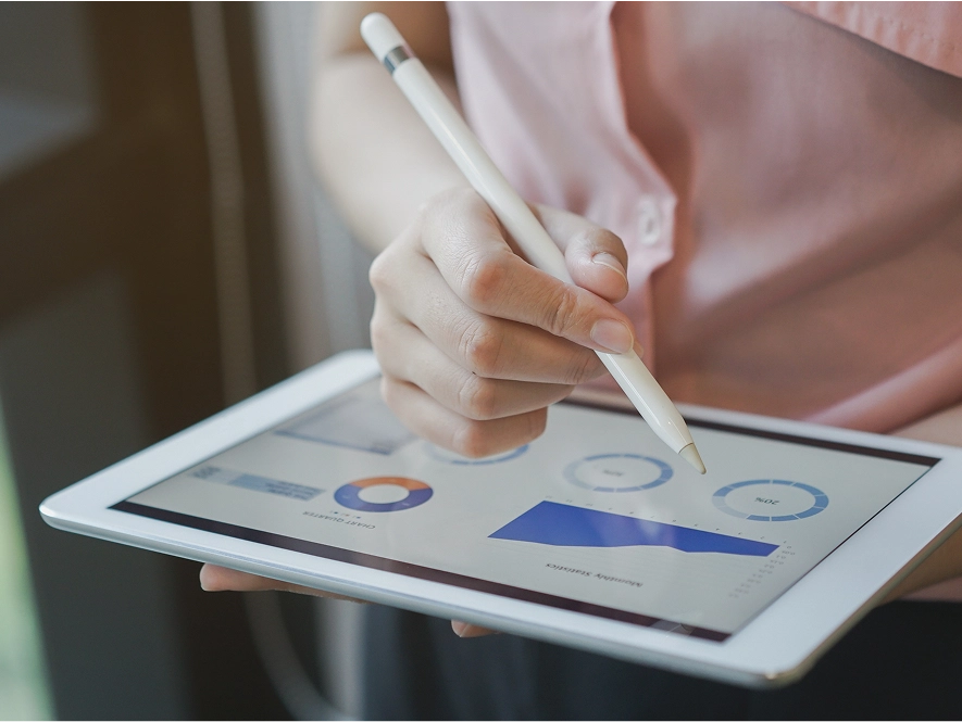 White label Meta account management, optimization and scaling — person using iPad with touch pen controlling performance graphs
