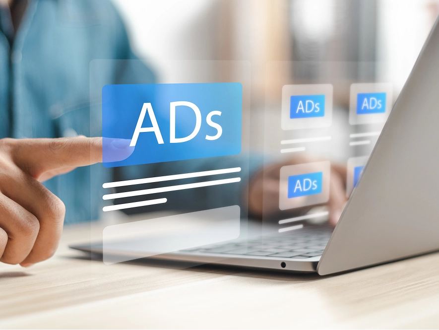 White label Meta campaign setup, ad building and audience targeting — 3D overlay on laptop displaying multiple ad layouts and targeting options