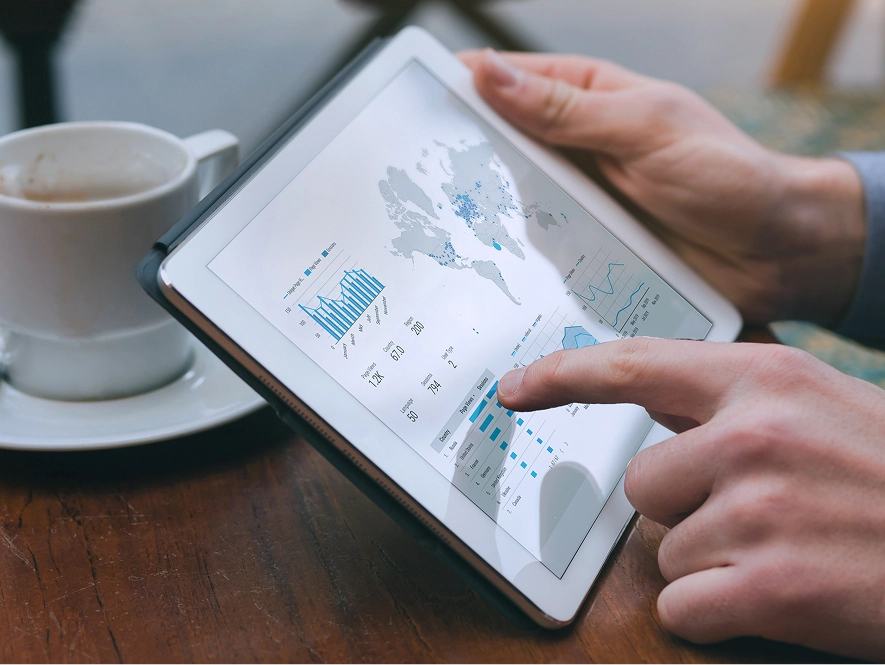 White label organic SEO services — professional reviewing SEO performance graphs on tablet placed on table to analyze rankings, traffic, and campaign results