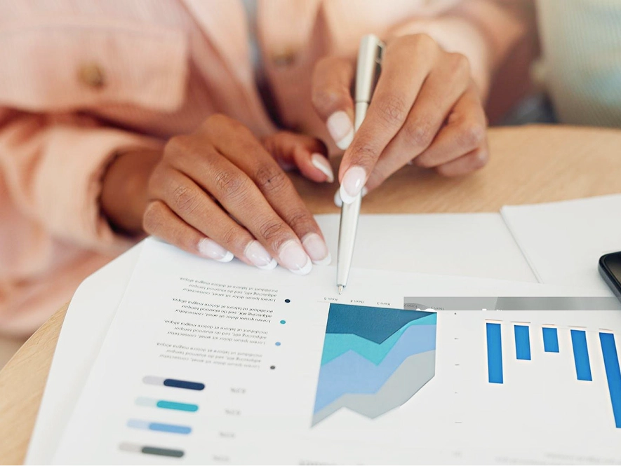 White label Oxygen Builder website performance and SEO — person reviewing website growth graphs in an open book with pen for guidance and planning
