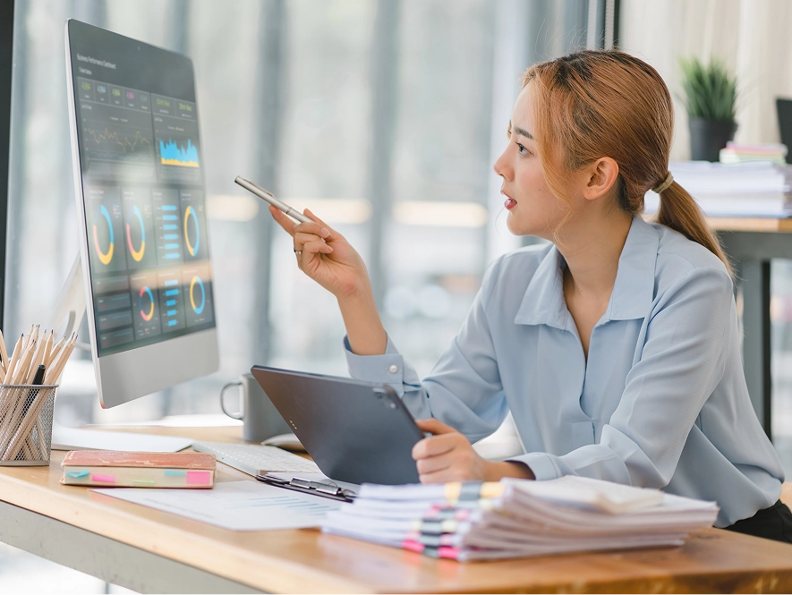 White label PPC reporting and insights — professional reviewing desktop analytics dashboard with performance graphs