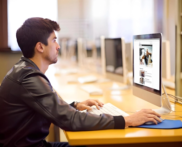 White label Shopify migration, optimization and ongoing support — professional working on desktop with ecommerce website visible on screen