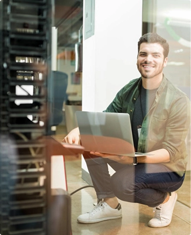 White label web hosting support — professional working on laptop ensuring server management and reliable hosting services