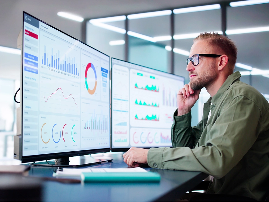 White label Wix built-in business and marketing tools — professional analyzing multiple screens with graphs and analytics for business growth