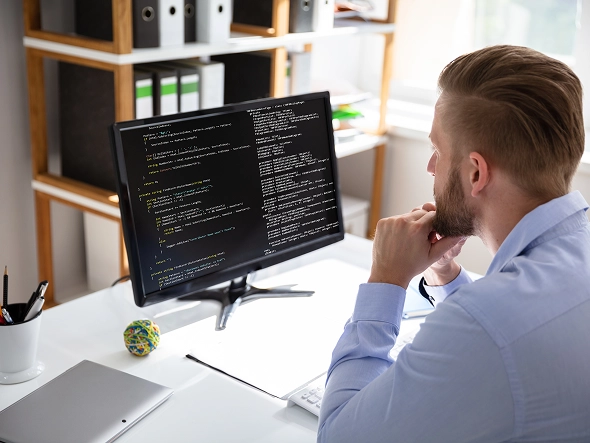 White label Wix website builder support and maintenance — user reviewing code and website setup on desktop for troubleshooting and updates