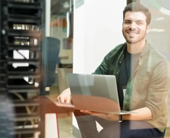 White label web hosting support — professional working on laptop ensuring server management and reliable hosting services