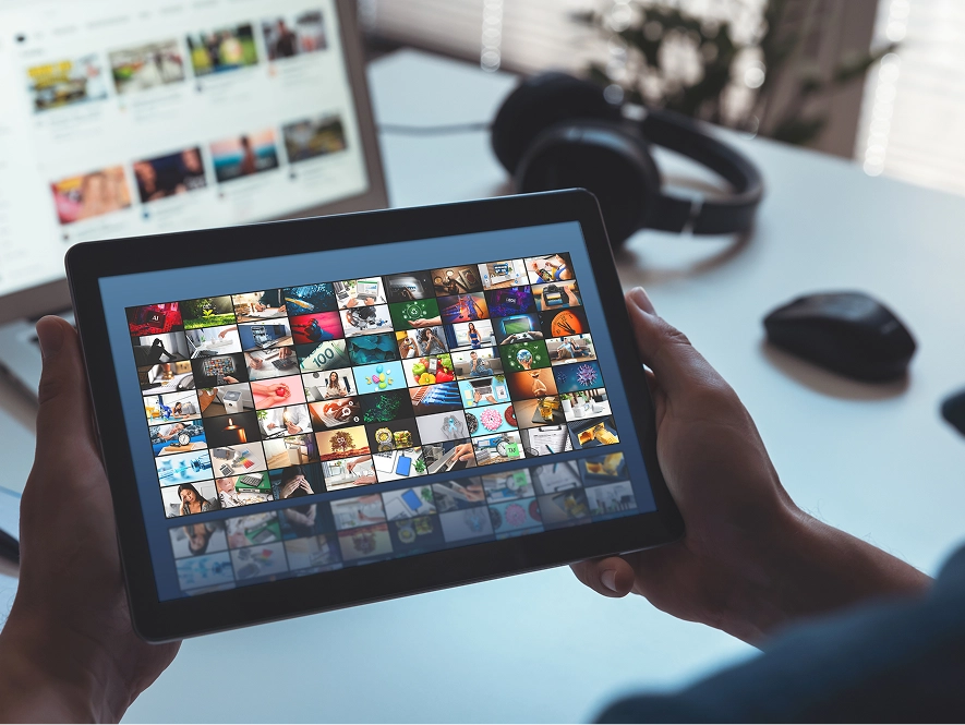 White label YouTube ad formats within multi-channel paid media mix — iPad displaying multiple video channels and campaign formats
