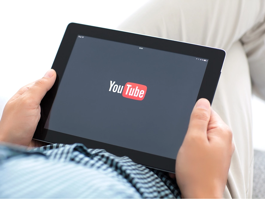 White label YouTube Ads strategy, funnel mapping and account setup — user opening YouTube on iPad for campaign planning